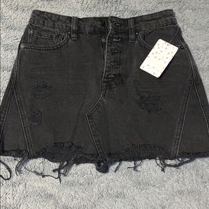 Distressed black denim skirt